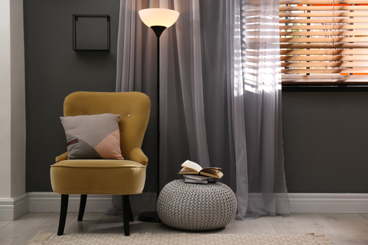 A window with layered drapery and blinds