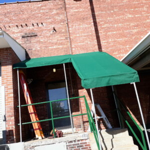Custom awning installation at Mr. K's Fabric Shop, Quincy, IL. Explore 50+ years of expertise in window treatments and upholstery.