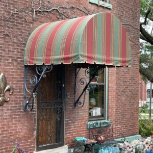 Custom awning at Mr. K's Fabric Shop in Quincy, IL, showcasing 50+ years of experience in window treatments and upholstery.