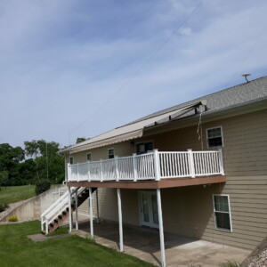 Custom retractable awning installed by Mr. K's Fabric Shop in Quincy, IL. Expert window treatments and upholstery solutions for 50+ years.