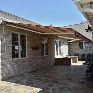 Custom retractable awning installation by Mr. K's Fabric Shop, Quincy, IL. Expert window treatments and upholstery for over 50 years.