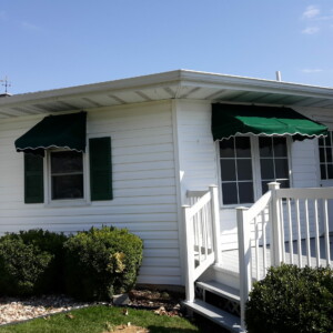 Custom awnings by Mr. K's Fabric Shop enhance this Quincy, IL home. Explore window treatments and upholstery solutions.