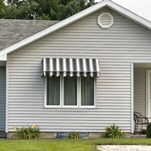 Custom awning by Mr. K's Fabric Shop in Quincy, IL, showcasing personalized window treatments and upholstery solutions.